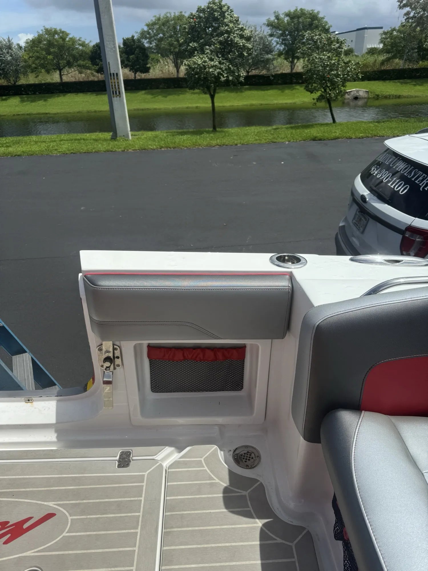 Grey coaming pad with red-trimmed netted storage pocket, built into a white and red center console