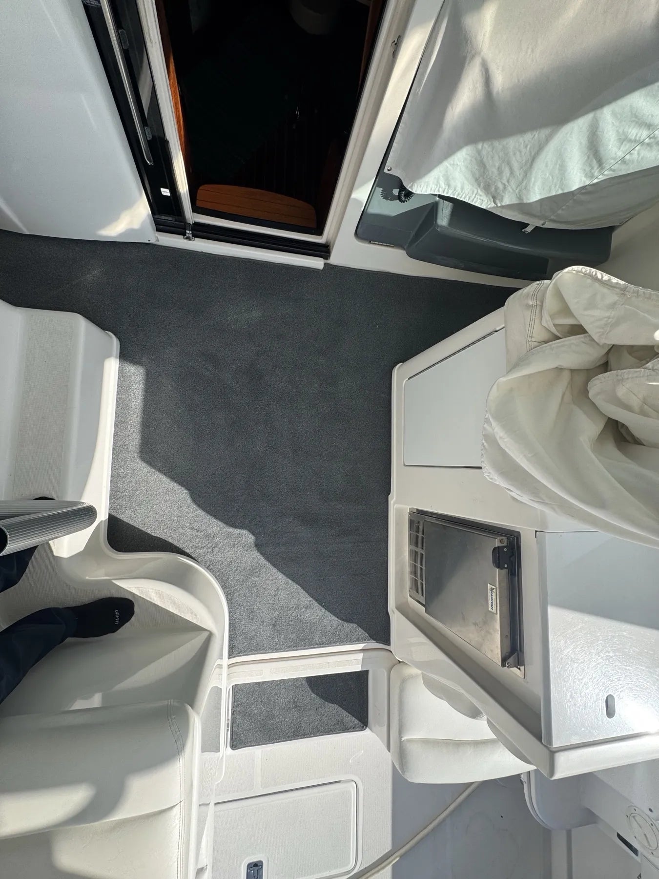 Cockpit carpet fitted around the cabin door, the helm seat base and the refrigerator cabinet