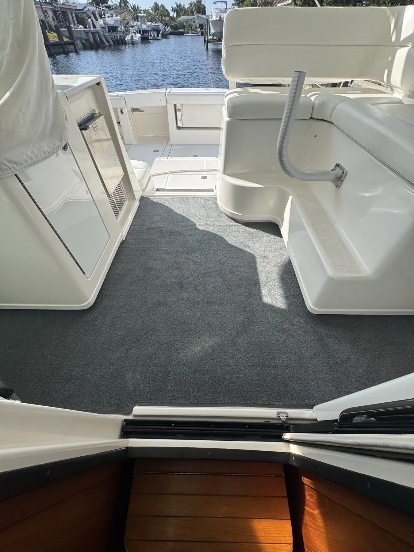 Charcoal marine carpet laid across a full cockpit sole, bound at every edge