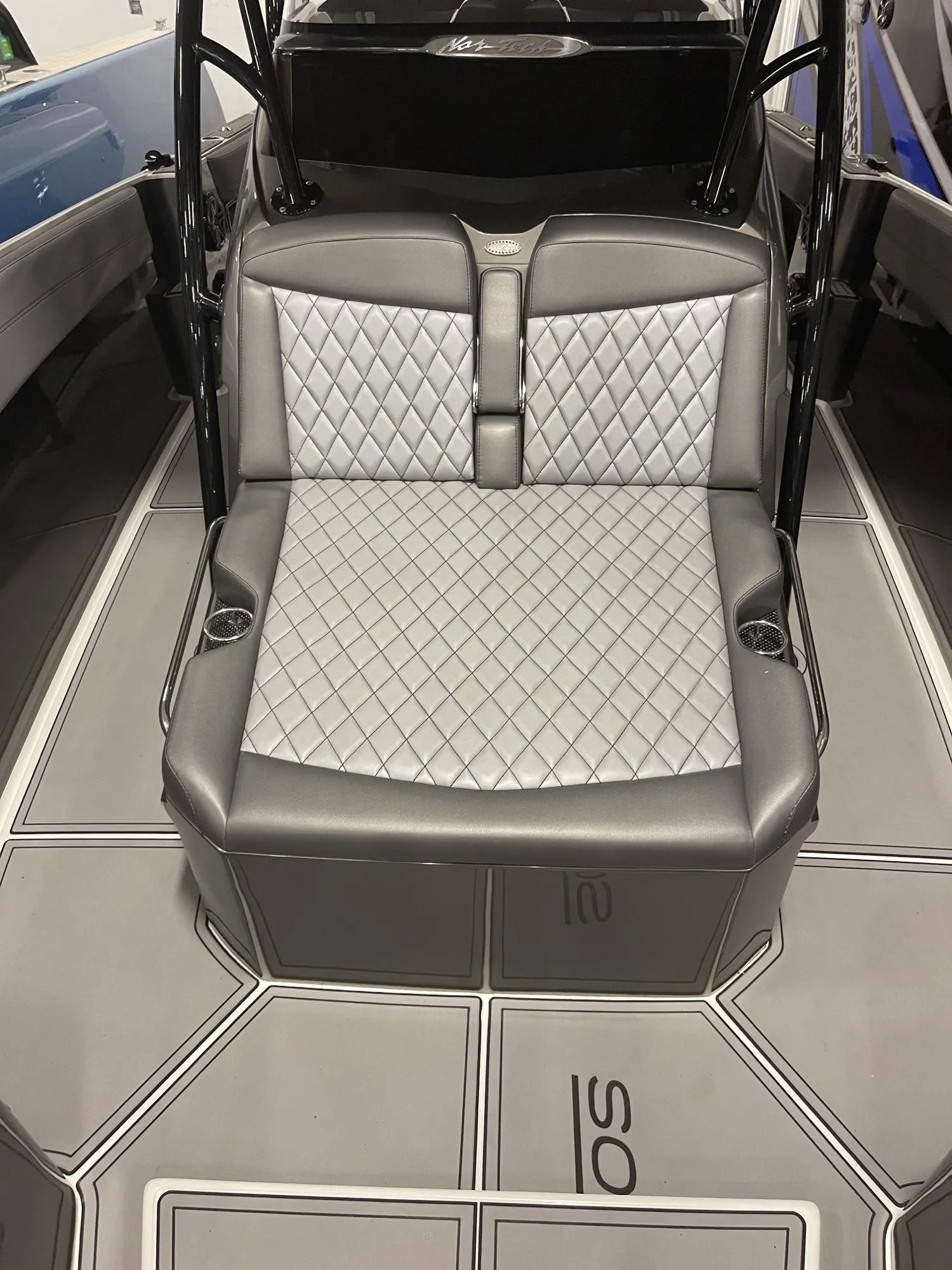 Nor-Tech aft lounge seat in silver diamond-stitch vinyl over charcoal bolsters, with matching grey EVA flooring, built by Rivers Refined in Oakland Park