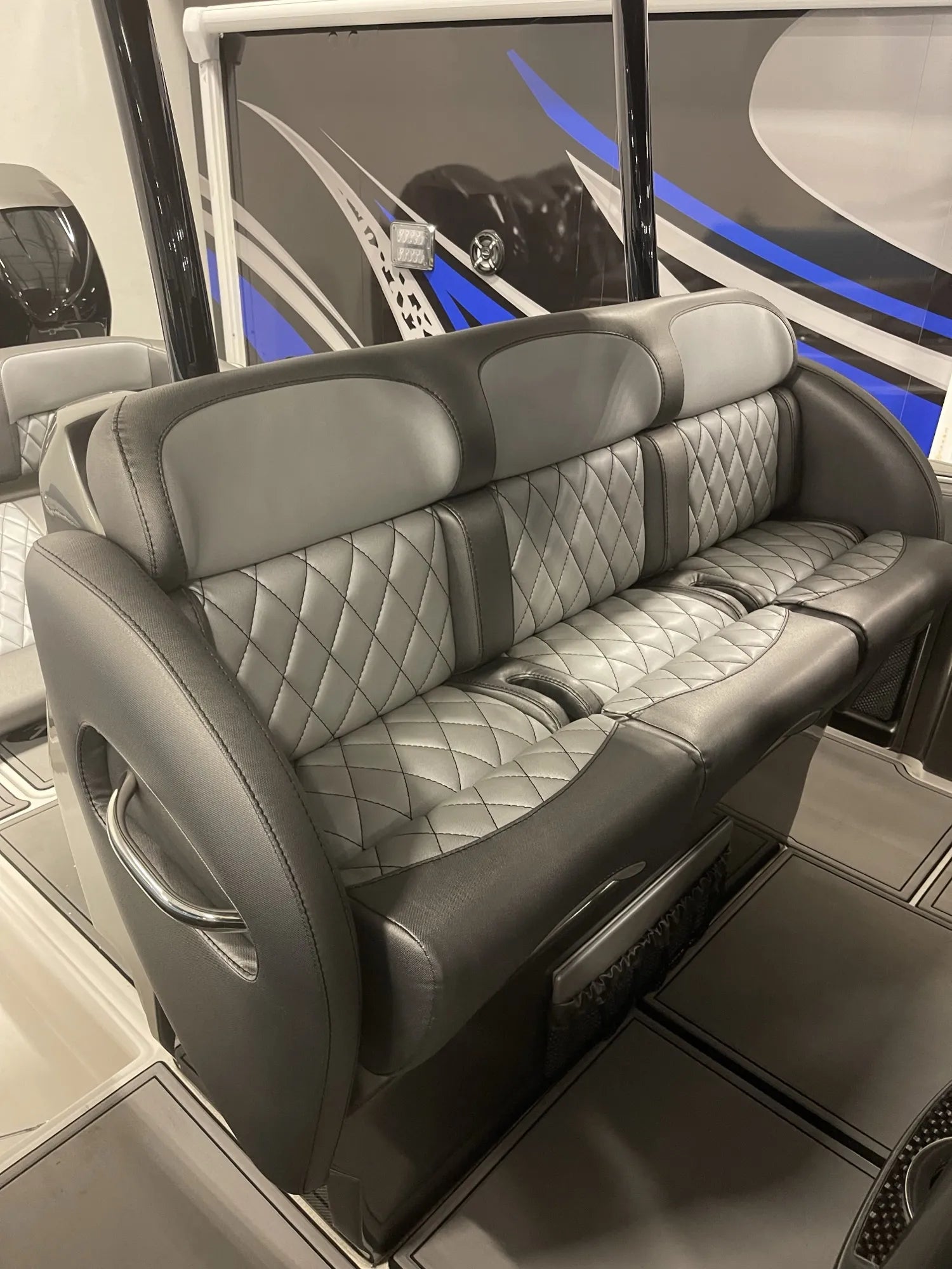 Three-across bench sofa with silver diamond-stitch centre panels, charcoal bolsters and a chrome grab rail, rebuilt by Rivers Refined